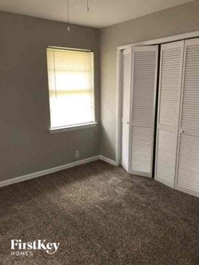 Garland house for rent - an empty bedroom with a closet and a window