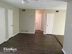 Garland house for rent - an empty living room with wood floors and white walls