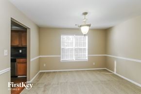 Douglasville house for rent - an empty dining room with a window and a light fixture