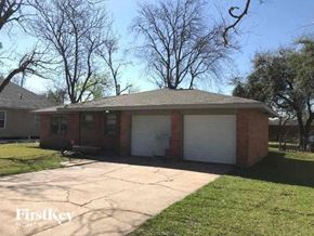 La Marque house for rent - A brick house with a white garage door is for sale.