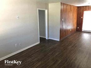 La Marque house for rent - A room with wooden floors and a white door.