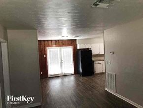 La Marque house for rent - A room with a black trash can and a white fridge.