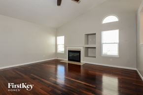 Indianapolis house for rent - A spacious living room with a fireplace and wood flooring.