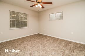 Mount Plymouth house for rent - the master bedroom has a ceiling fan and a carpeted floor