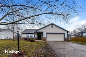 Indianapolis house for rent - a white house with a driveway and a tree