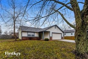 Indianapolis house for rent - the front of a house with a yard and trees