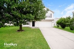 Indianapolis house for rent - A white house with a tree in front of it.