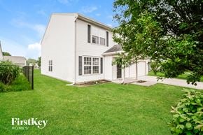 Indianapolis house for rent - A white house with a green lawn in front of it.