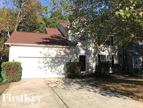 Charlotte house for rent - A house with a white exterior and a brown roof is shown with the logo "FirstKey Homes" in the bottom left corner.