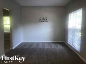 Charlotte house for rent - A room with a chandelier and a window with blinds.