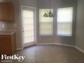 Charlotte house for rent - A room with a wooden cabinet and a chandelier hanging from the ceiling.
