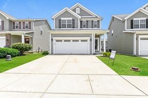 Saint Charles house for rent - a gray house with a white garage door on a driveway