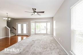 Saint Charles house for rent - an empty living room with a ceiling fan and a carpet