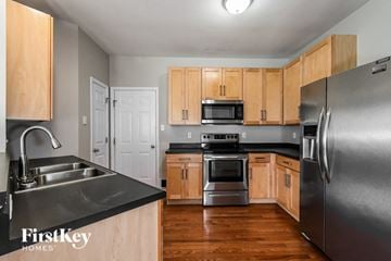 Saint Charles house for rent - a kitchen with wooden cabinets and stainless steel appliances