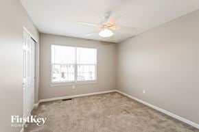 Saint Charles house for rent - a bedroom with carpet and a ceiling fan and a window