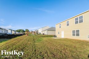 Winston-Salem house for rent - A grassy field with a few houses and a tent in the distance.