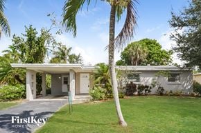 Fort Lauderdale house for rent - a small white house with a palm tree in front of it