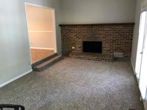 Dacula house for rent - A room with a fireplace and a doorway leading to another room.