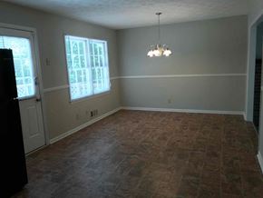 Dacula house for rent - A room with a tile floor and a chandelier.