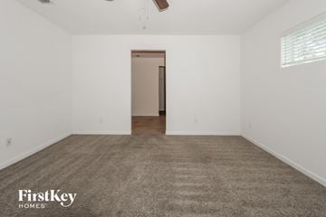 Port St. Lucie house for rent - the spacious living room with carpet and white walls