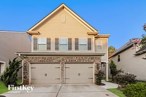 Mcdonough house for rent - A two-car garage is attached to a two-story house.