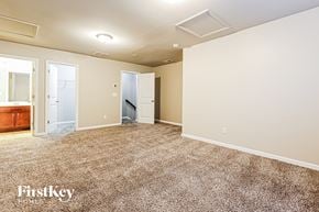 Mcdonough house for rent - A spacious room with beige walls and carpeted floor.