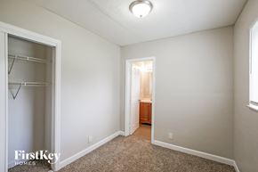 Lauderhill house for rent - A bedroom with a carpeted floor and a small closet.