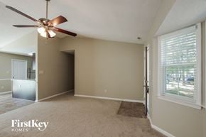 Monroe house for rent - A room with a fan and a rug on the floor.