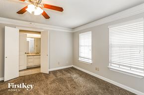 Humble house for rent - a bedroom with a carpeted floor and a ceiling fan