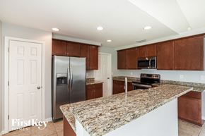 Cape Coral house for rent - a kitchen with granite counter tops and stainless steel appliances