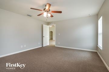 Cape Coral house for rent - a living room with a ceiling fan and a carpet