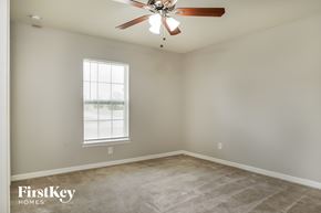 Cape Coral house for rent - a bedroom with a ceiling fan and a window