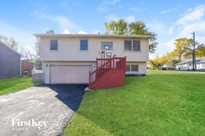 Mchenry house for rent - a white house with a red staircase in front of a lawn