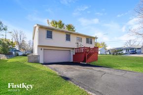 Mchenry house for rent - a white house with a red porch and a driveway