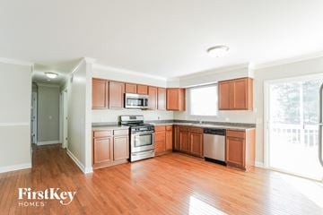 Mchenry house for rent - a kitchen with wood flooring and wooden cabinets