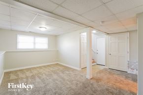 Mchenry house for rent - a bedroom with white walls and carpet and a door to a closet