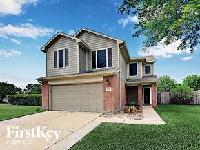 Pinehurst house for rent - a house with a garage door and a lawn