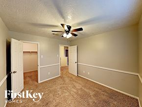 Pinehurst house for rent - a bedroom with a ceiling fan and a closet