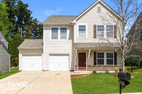 Charlotte house for rent - a white house with a garage and a driveway