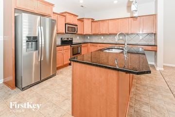 Charlotte house for rent - a large kitchen with wooden cabinets and stainless steel appliances