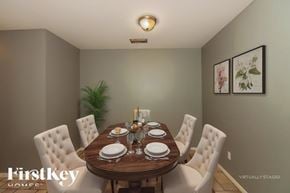 Missouri City house for rent - A dining room with a wooden table set for four.