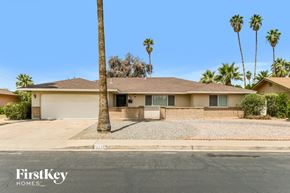 Tempe house for rent - A house with a palm tree in front of it.