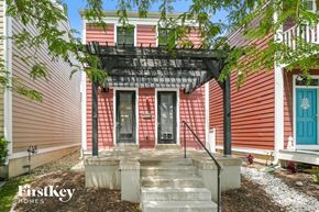 Saint Charles house for rent - A house with a red siding and a black awning.