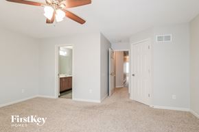 Saint Charles house for rent - A spacious room with a ceiling fan and a carpeted floor.