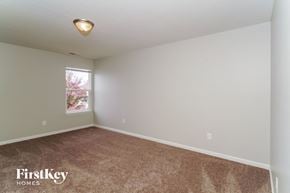 Indianapolis house for rent - the upstairs bedroom with carpeting and a window