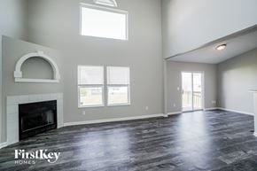 Columbus house for rent - an empty living room with a fireplace and windows