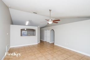 Palm Bay house for rent - a living room with a ceiling fan and a tiled floor