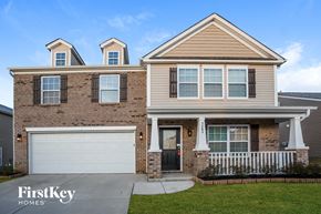 Concord house for rent - A two-story house with a garage and a front porch.