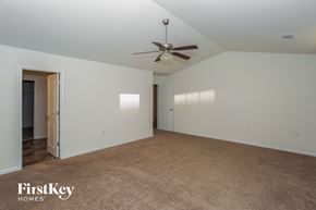 Concord house for rent - A spacious room with a ceiling fan and carpeted floor.
