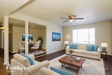 Phoenix house for rent - A living room with a white couch and a wooden coffee table.